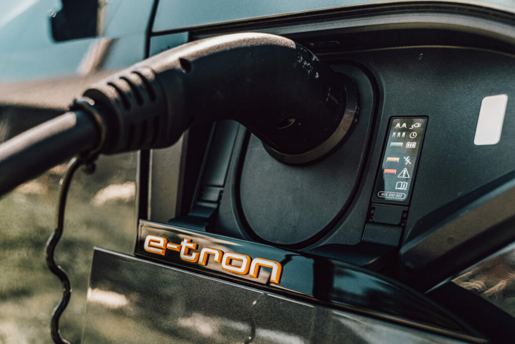 Audi e-tron Sportback plugged in for charging at an electric car charging station