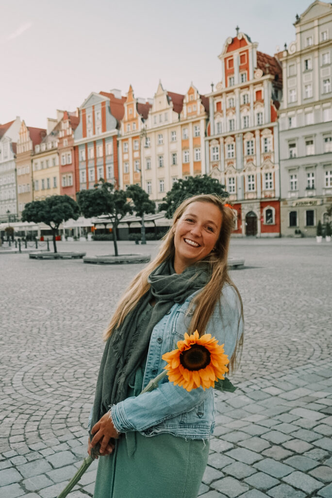 Girl with sunflower on the market square of Wroclaw