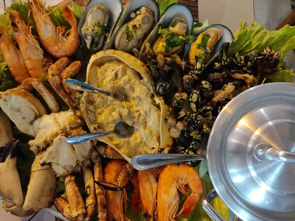 A large Portuguese seafood platter with mussels, shrimp, crab, and clams, showcasing traditional coastal cuisine made with fresh, locally sourced ingredients.